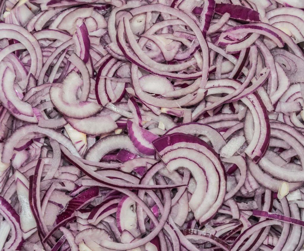 cutting onions to prepare fried onions